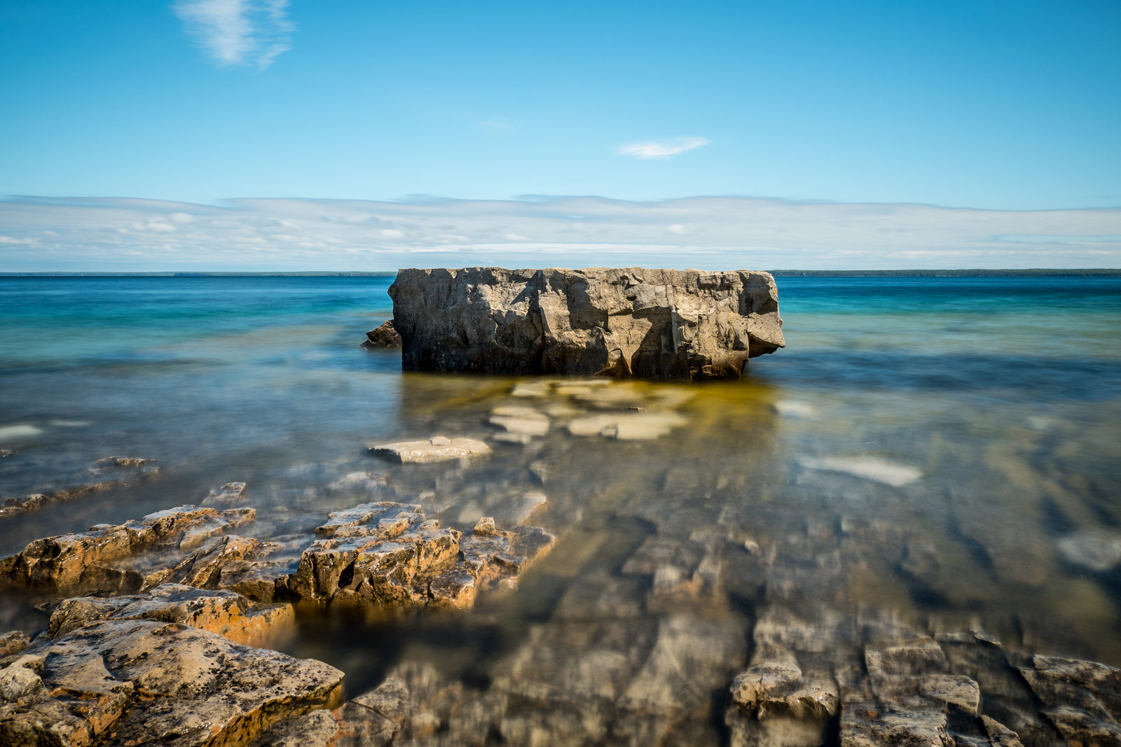 Clear water over rocks on a bright day
